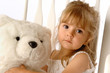 Young Girl in a Chair with her Teddy Bear