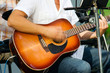 man is playing on acoustic guitar