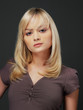 Portrait of fresh and beautiful blond woman on grey background