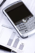 pen and phone laying on report with diagrams