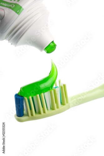 Photo: toothbrush, green toothpaste and tube isolated toothbrush, green toothpaste and tube isolated