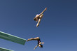 Two women diving from diving board