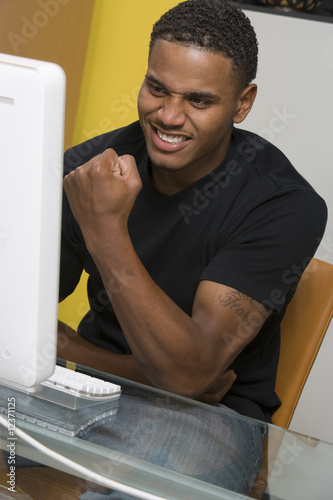 Photo: Young Man Using Desktop Computer Young Man Using Desktop Computer