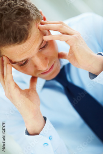 Photo: Young businessman in the office and thinking about business Young businessman in the office and thinking about business