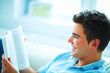 Smiling handome young man reading a book Smiling handome young man reading a book