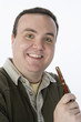 Portrait of mid-adult man holding pen, smiling