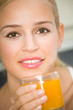 Young attractive happy woman with glass of juice
