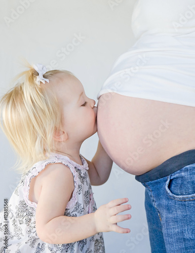 Photo: Little Girl Kissing New Sibling to Be Little Girl Kissing New Sibling to Be