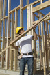 construction worker holding planks