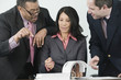 Three businesspeople looking at documents