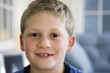 Close up of a boy smiling.