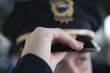 Close up of a female police woman's hand adjusting cap..