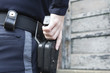 Police woman drawing handgun from holster..
