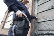 Female police standing outside the door with a gun..