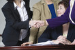 Photo: View of businesswoman shaking hands by colleagues. View of businesswoman shaking hands by colleagues.