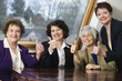 Photo: Portrait of smiling business women sitting by a table. Portrait of smiling business women sitting by a table.
