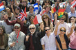 Crowd holding up National flags