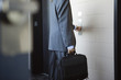 A young Business man pushing button of an elevator.
