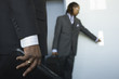 A young business man pressing push button of an elevator.