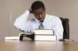 Photo: View of business man with books in an office. View of business man with books in an office.