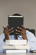 Photo: A young Business man reading books in an office. A young Business man reading books in an office.