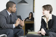 Business colleagues conversing in an office.