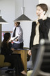 Business woman talking on cellphone and businessman