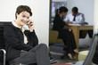 Business woman on cellphone with business colleague