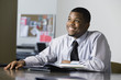 Business man smiling in an office.