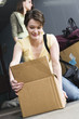 Woman packing cardboard box.