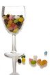 Foto: jelly beans in wine glass, reflected in glossy surface jelly beans in wine glass, reflected in glossy surface