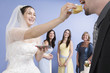 Young bride feeding the groom a piece of cake..