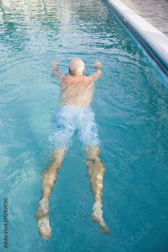 Photo: Senior man swimming in a pool Senior man swimming in a pool