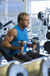 man weightlifting with dumbbells