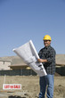 Construction worker holding building plans