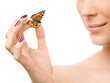 Young beautiful woman holding a butterfly
