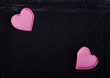 Two pink hearts isolated on black velvet background. Empty space Two pink hearts isolated on black velvet background. Empty space