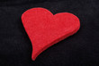 Close up of red heart isolated on black velvet background. Studi Close up of red heart isolated on black velvet background. Studi