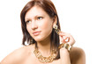 Gorgeous young woman wearing expensive golden jewelery