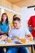 Portait of young students having lunch