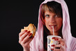woman with hamburger and beverage