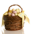 wicker basket with easter eggs and a yellow ribbon