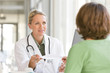 Photo: Attractive young caring doctor talking to patient Attractive young caring doctor talking to patient