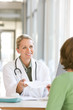 Photo: Attractive young caring doctor talking to patient Attractive young caring doctor talking to patient