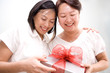 lady giving gift and hug