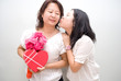 asian girl kissing mother