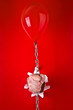 Hand holding red balloon
