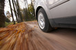 Car driving on country road.