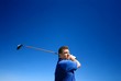 A man swinging a golf club A man swinging a golf club