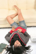 Young woman relaxing on floor with laptop and headphone